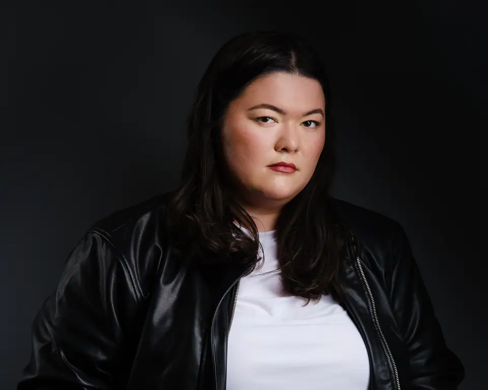 Moody actor headshot of a woman in a black leather jacket