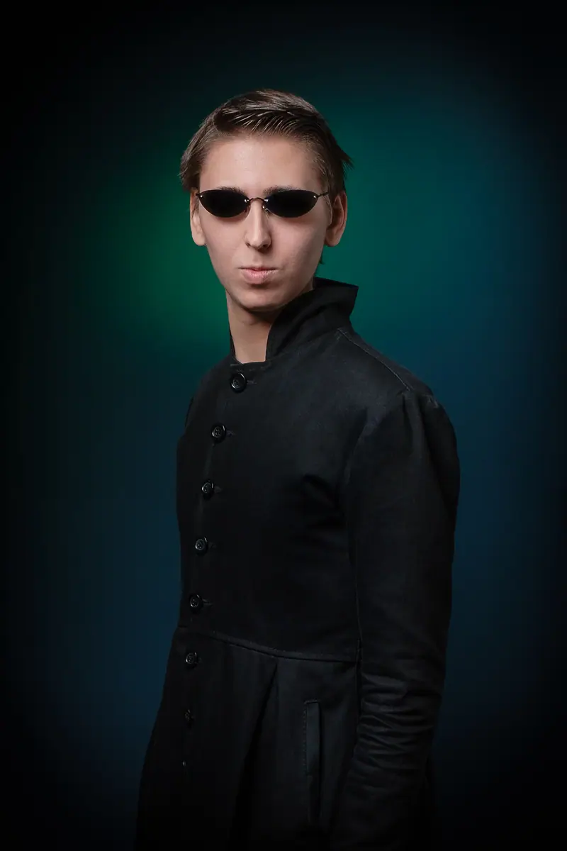 Character actor portrait of a man in sunglasses on a dark green backdrop