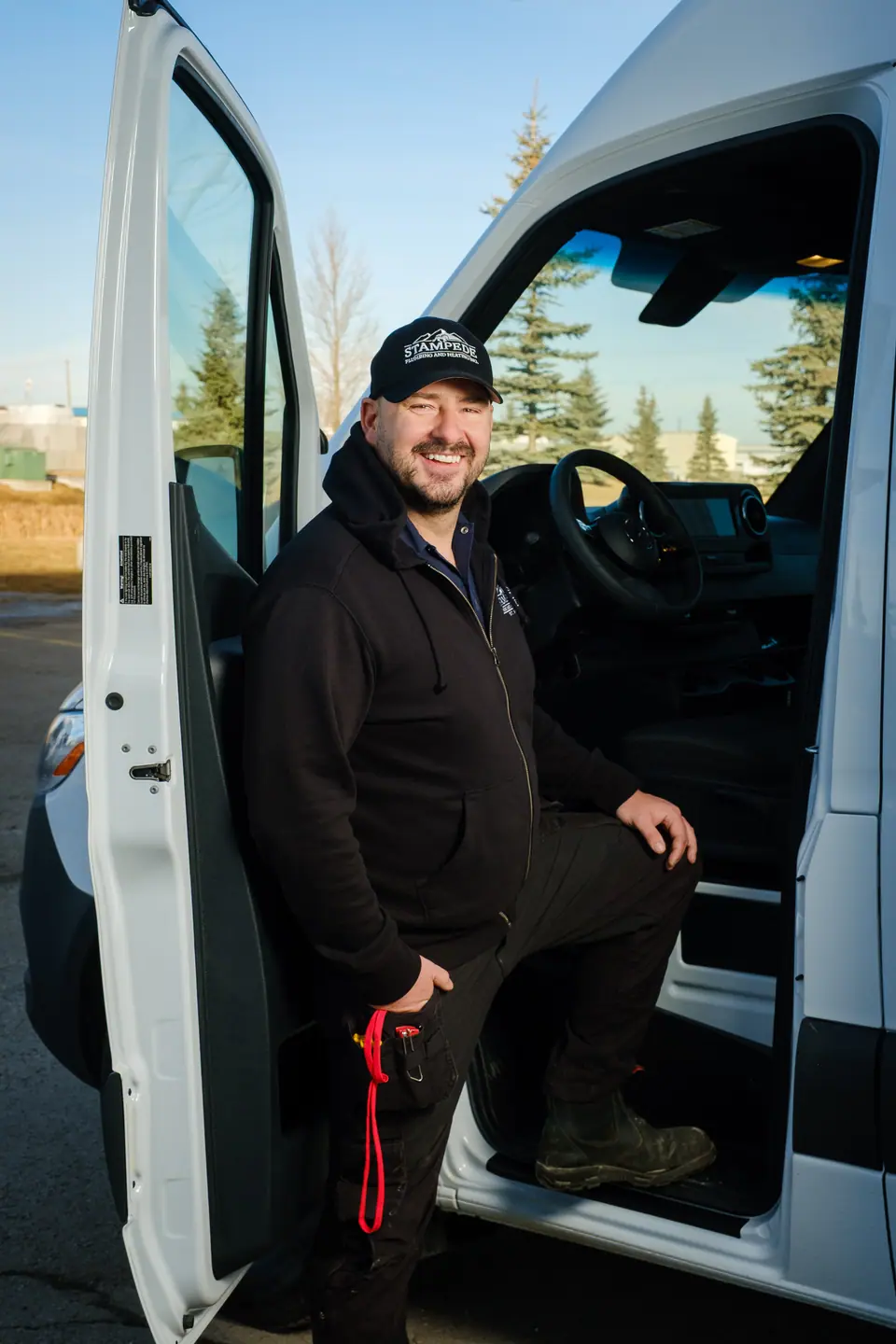 Personal branding portrait of a business owner stepping out of his work van