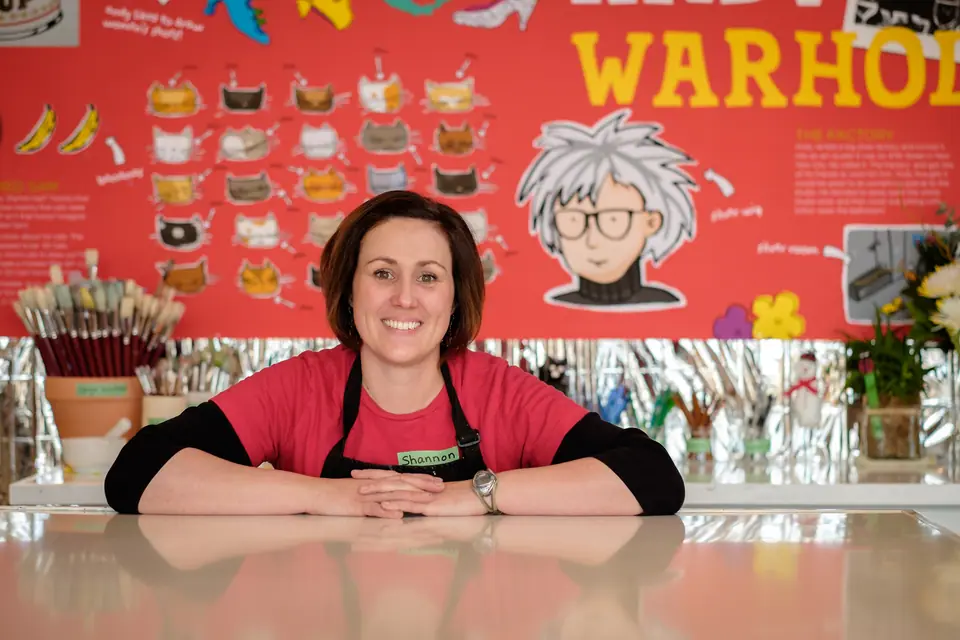 Business owner portrait at a restaurant counter in front of a colourful mural