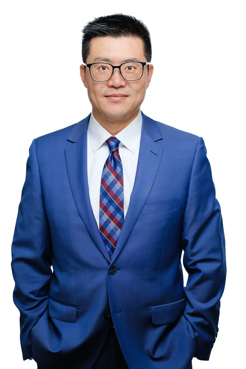 Full corporate portrait of a man in a bright blue suit on white
