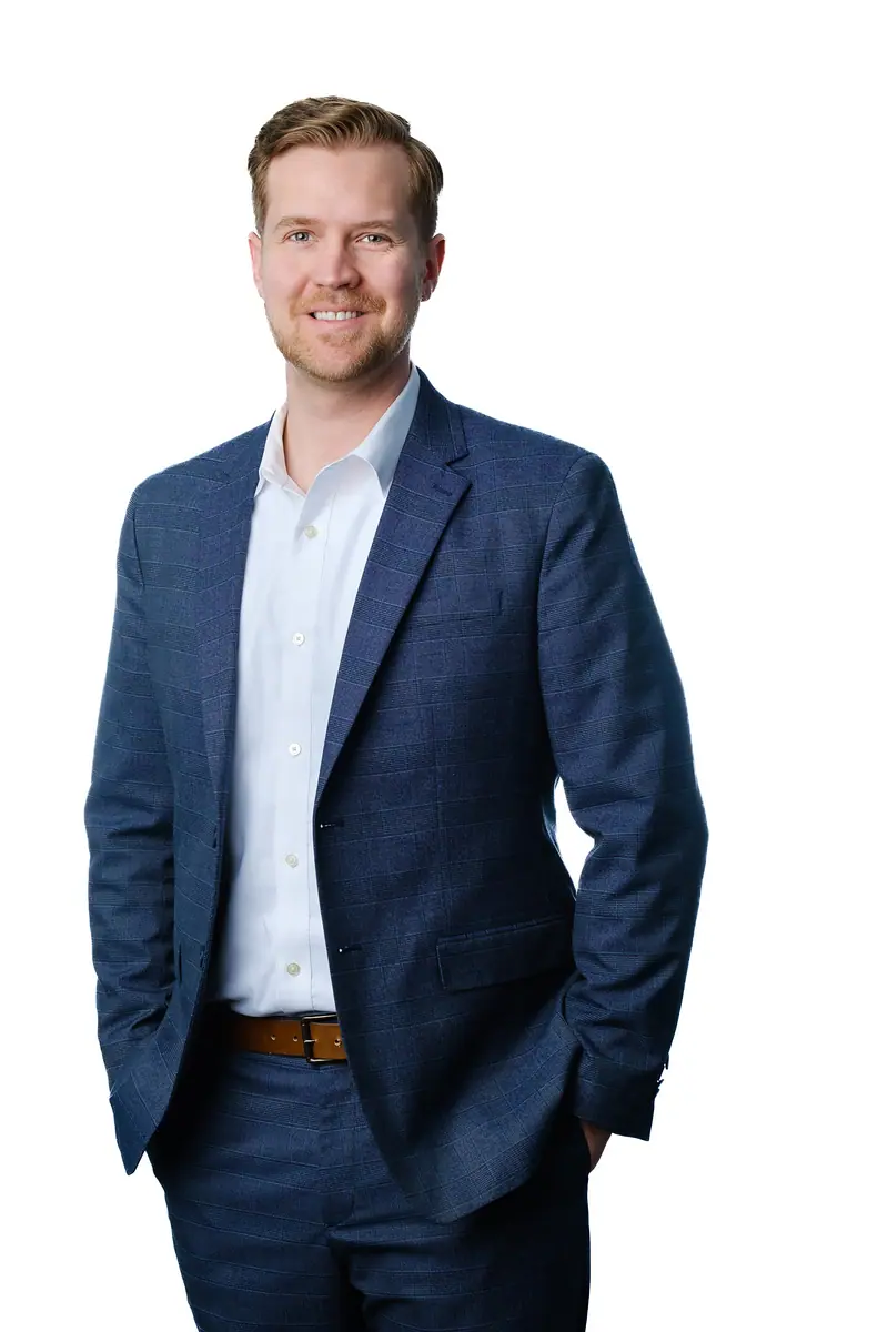 Full length corporate portrait of a man in a navy suit on white