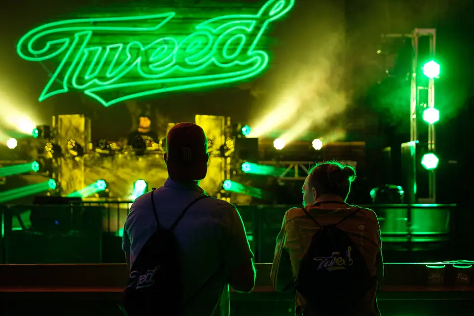 Live band on a stage lit green at a corporate celebration