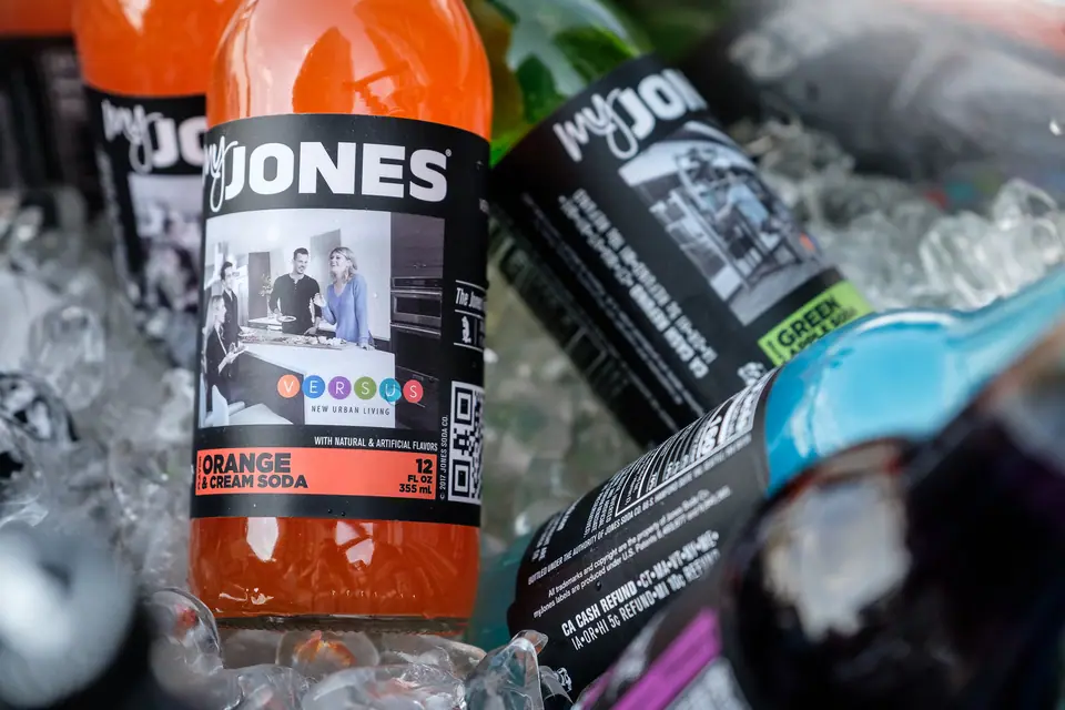 Branded soda bottles on ice at an event bar