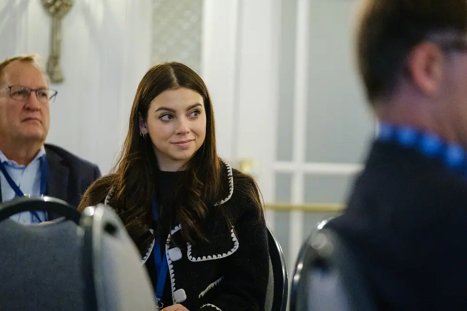 Candid photo of a smiling guest at a conference table