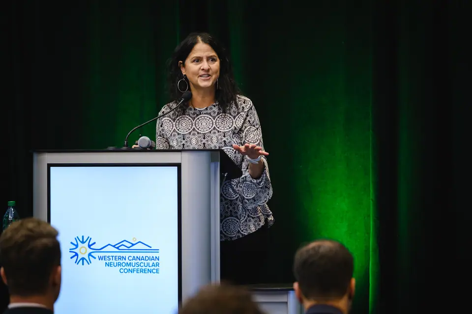 Keynote speaker at a podium on a conference stage