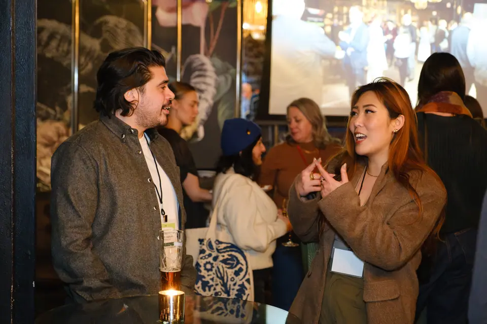 Guests in conversation at an evening networking reception