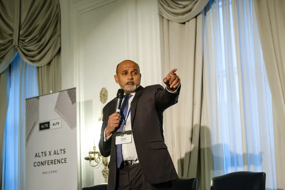 Speaker presenting in a ballroom at a business conference