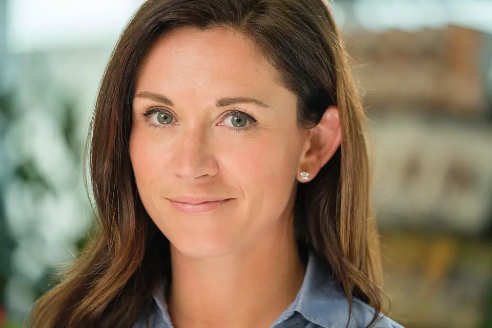On location headshot of a woman with a softly blurred city background