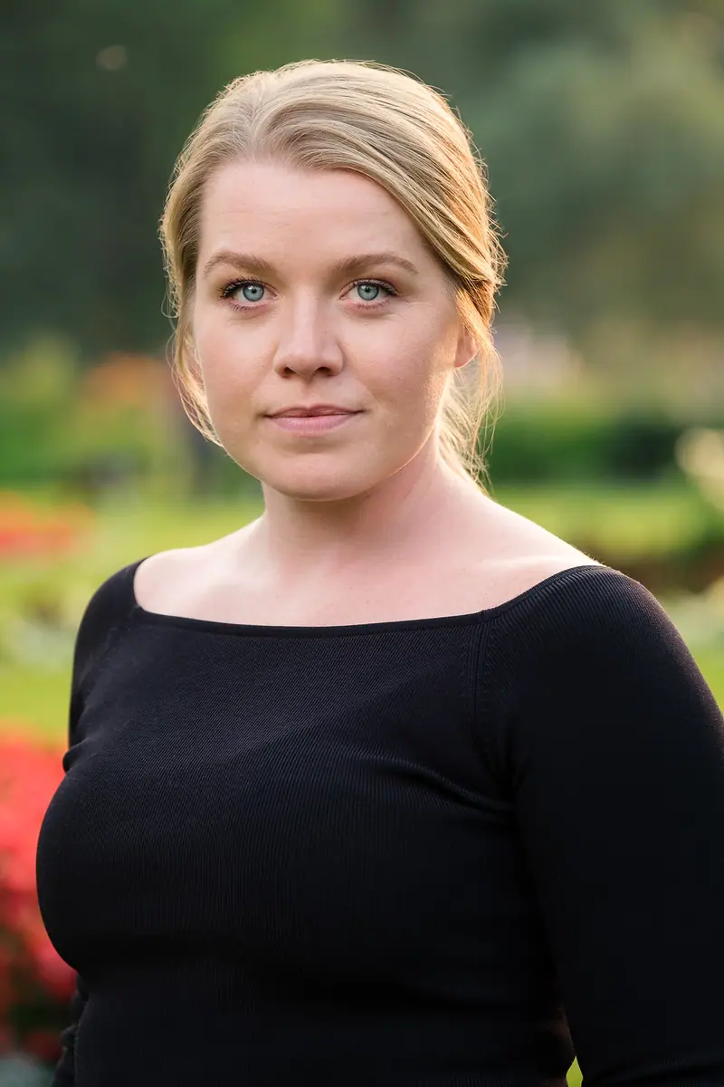 Outdoor portrait of a woman in a black top in a garden