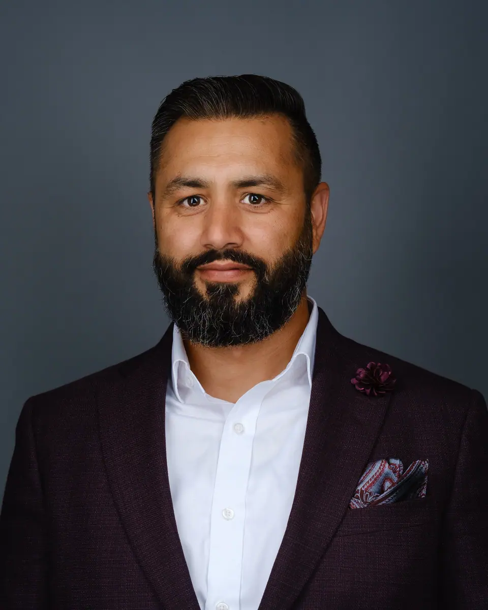 Realtor headshot of a man with a beard in a burgundy blazer